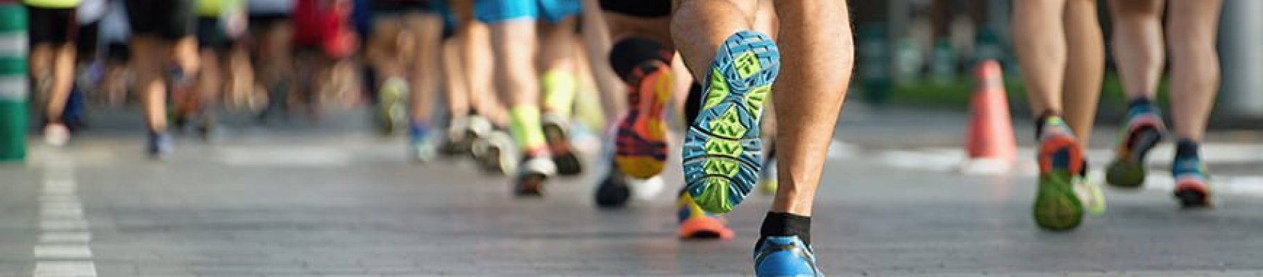Marathon running race, people feet on city road Orthopedic Specialist in Fairfax VA treating runners, walkers and other atheletes